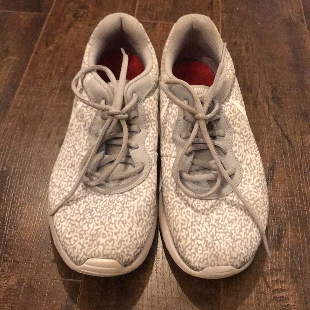 Gray and white patterned Nike running shoes